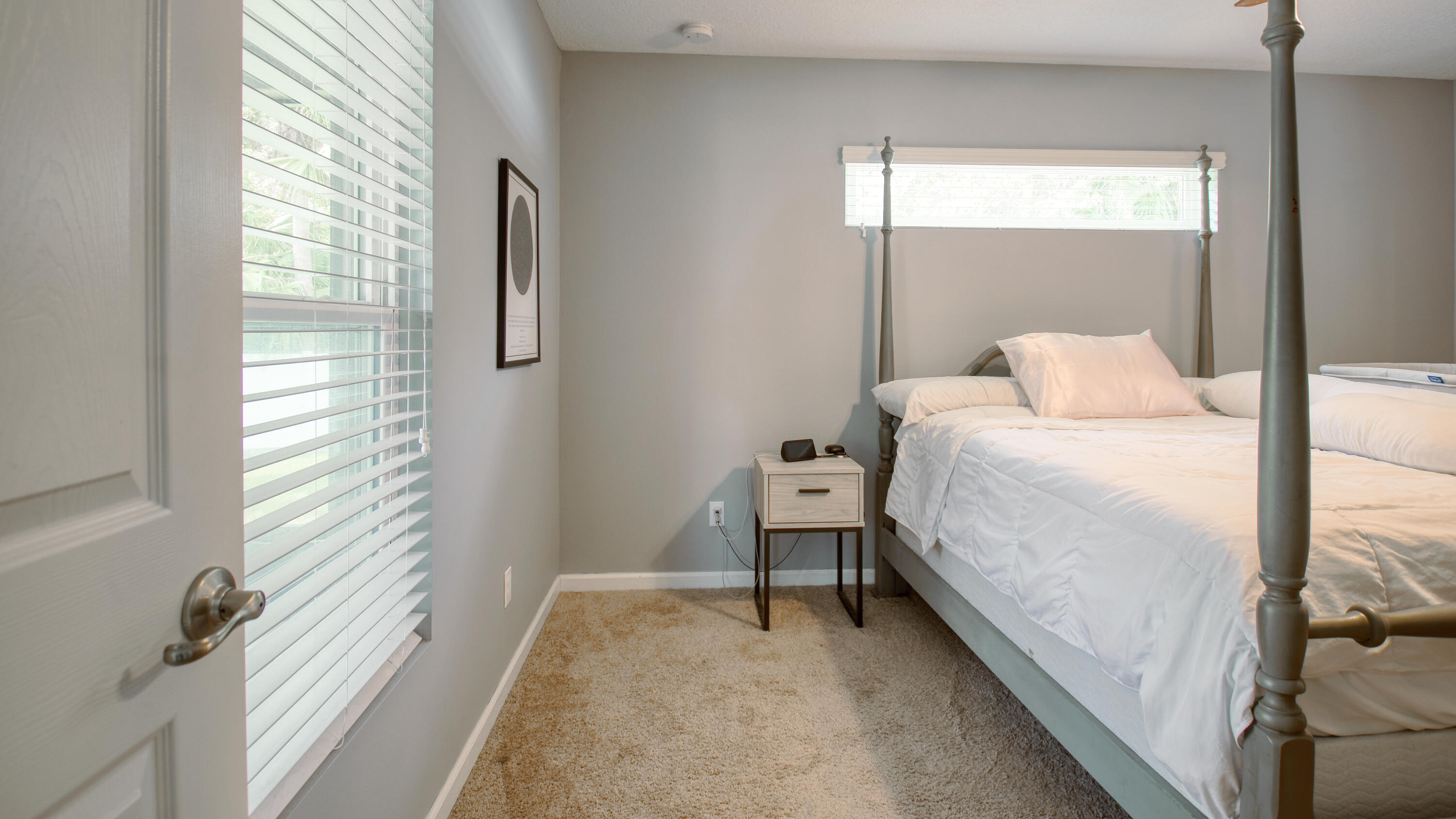 1780 Southwest Leafy Road Port St. Lucie, FL 34953 - Photo 11 of 30 a bedroom with a bed and lamp with window