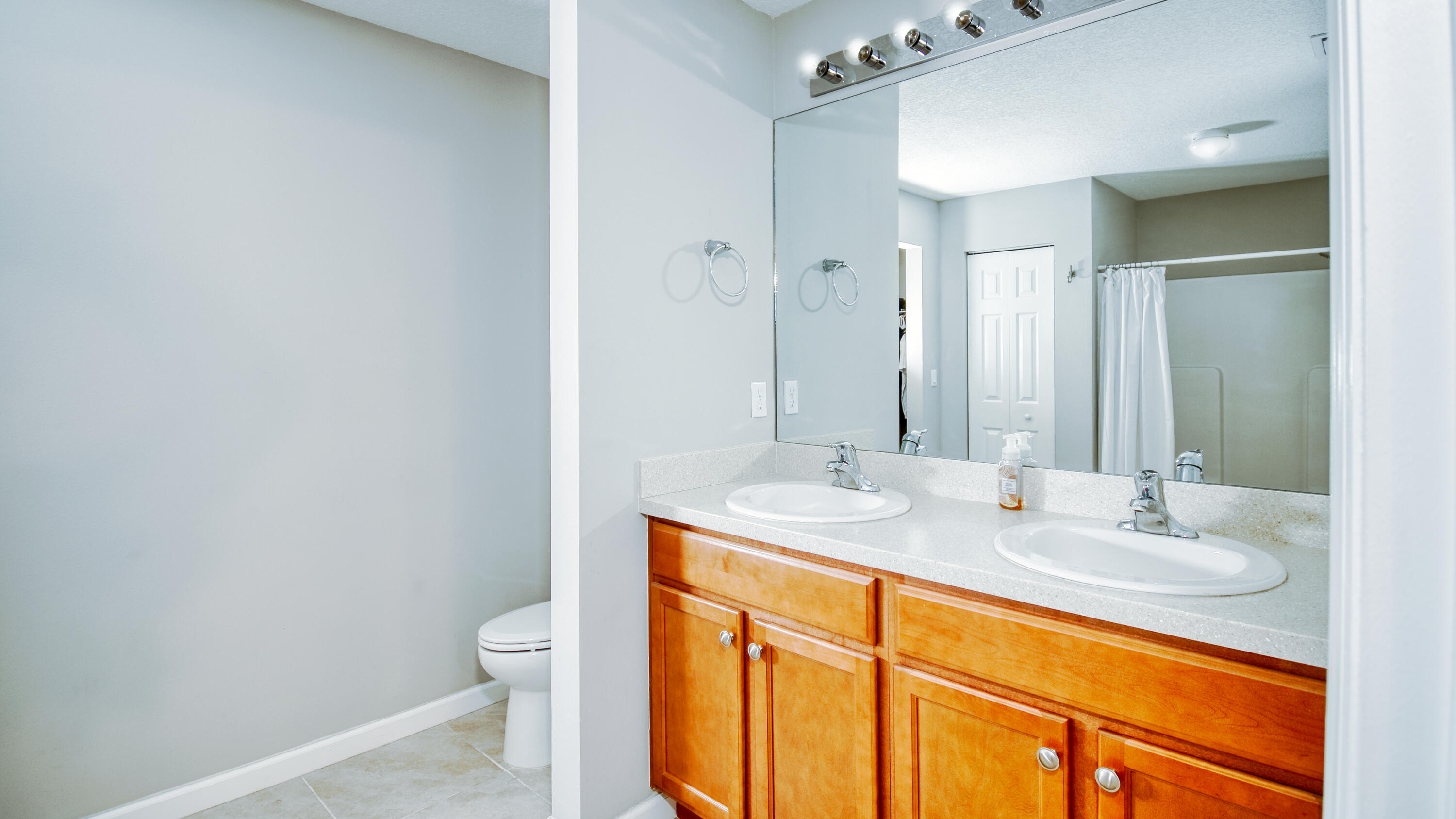 1780 Southwest Leafy Road Port St. Lucie, FL 34953 - Photo 13 of 30 a bathroom with a granite countertop sink toilet and mirror