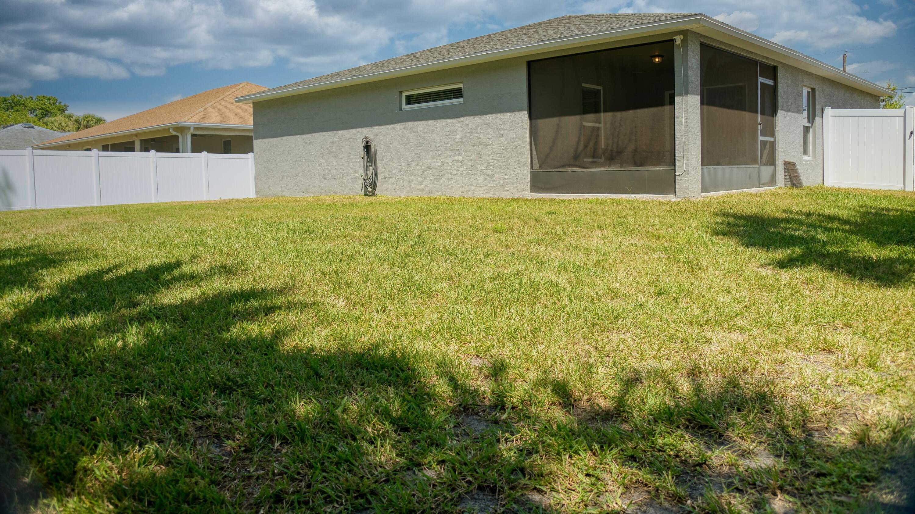 1780 Southwest Leafy Road Port St. Lucie, FL 34953 - Photo 28 of 30 a front view of a house with a yard