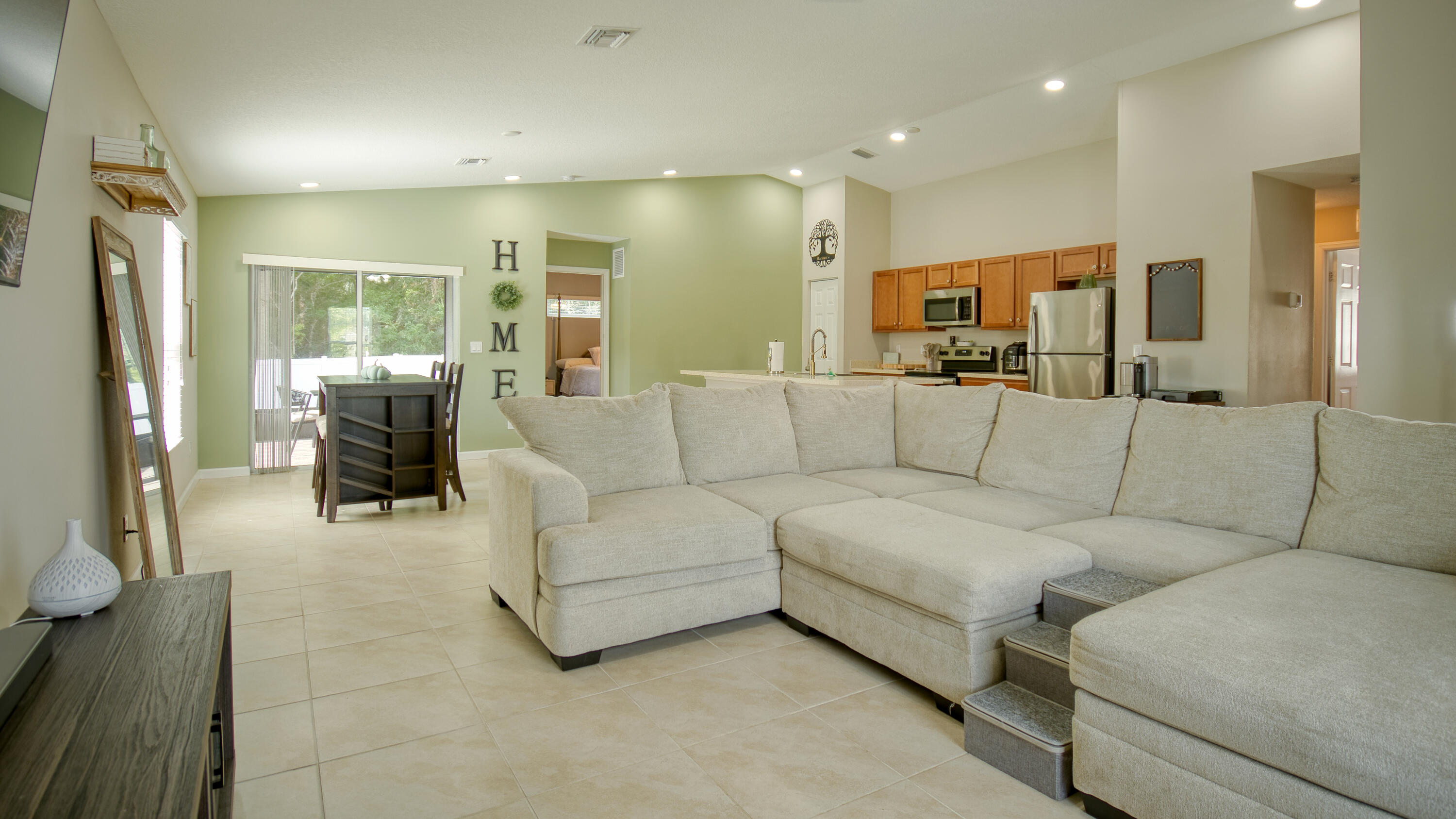 1780 Southwest Leafy Road Port St. Lucie, FL 34953 - Photo 8 of 30 a living room with furniture and a chandelier