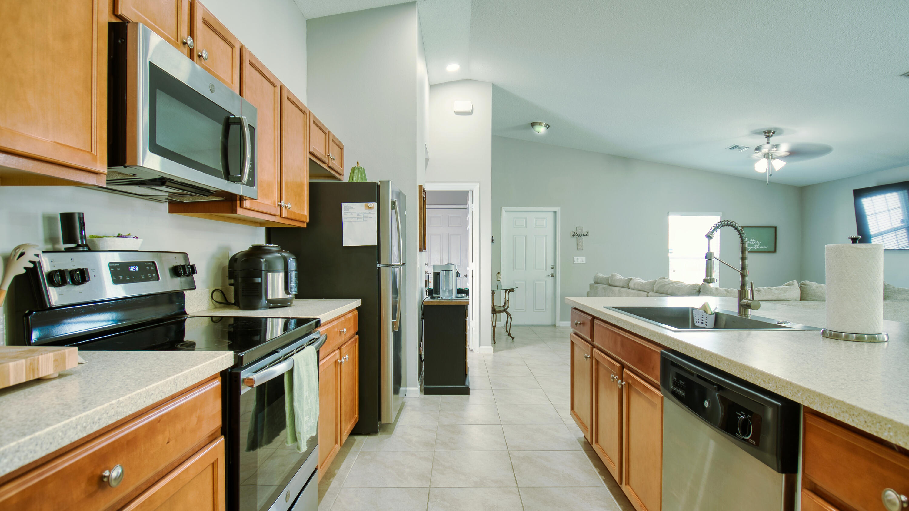 1780 Southwest Leafy Road Port St. Lucie, FL 34953 - Photo 10 of 30 a kitchen with stainless steel appliances granite countertop a sink a stove and a refrigerator