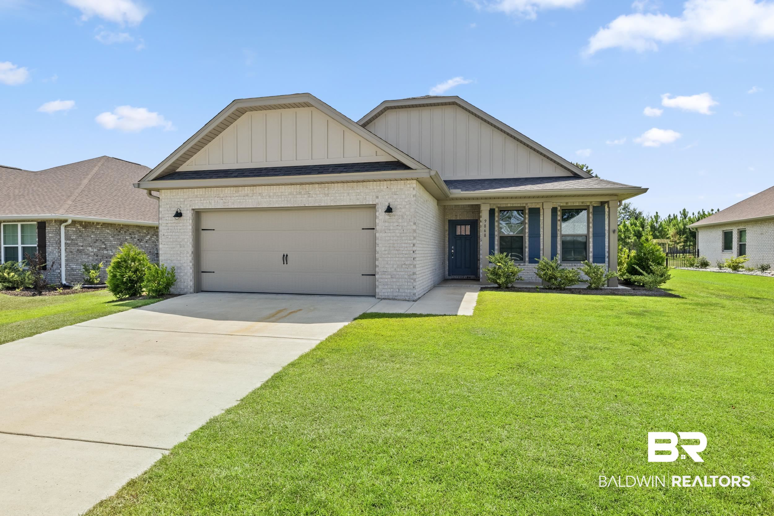 View of front of property with a front lawn and a garage