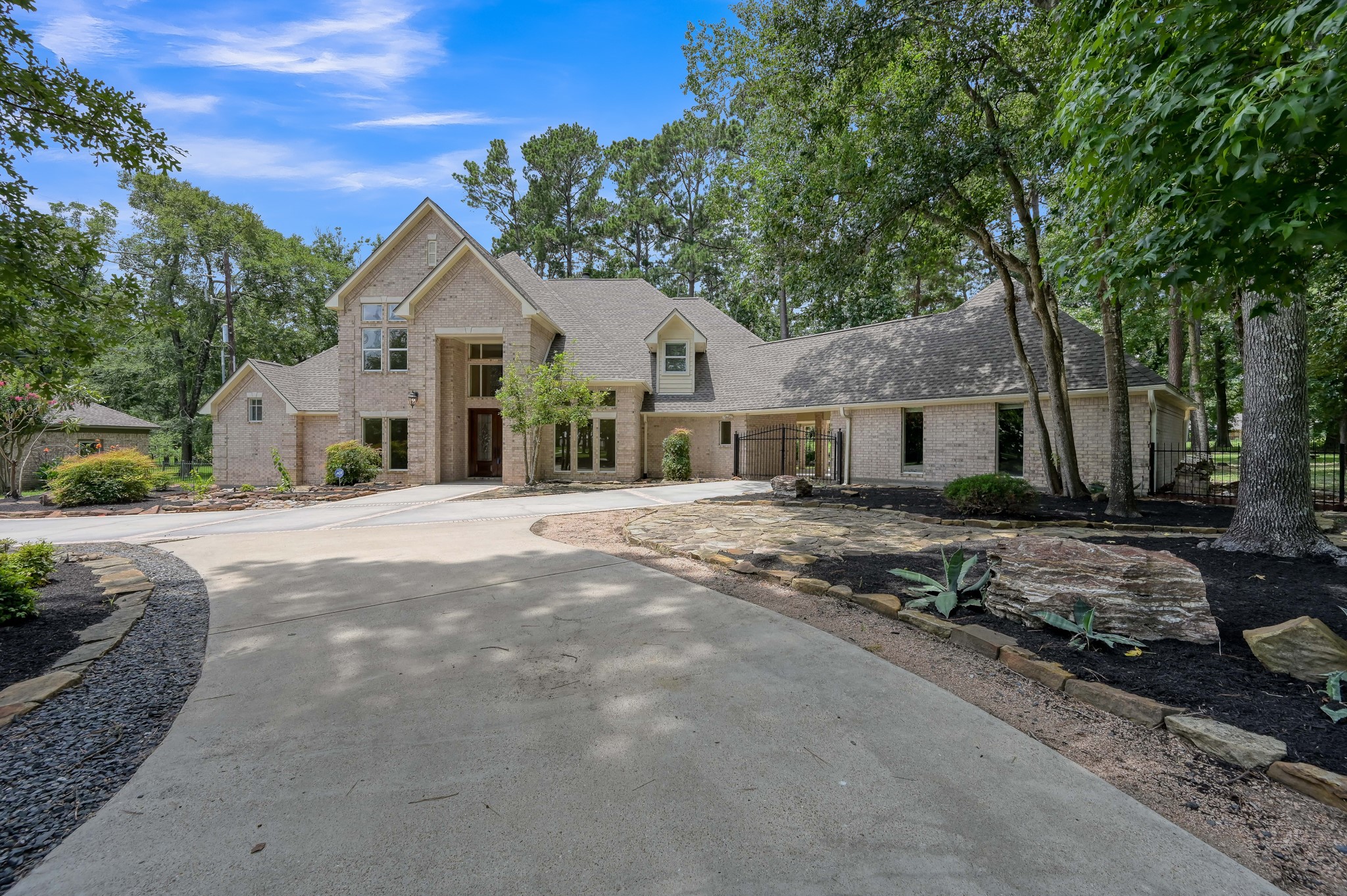 2205 Longmire Road Conroe, TX 77304 - Photo 3 of 49 Gated porte-cochère gives added security to your backyard, 2 car garage and 3 car covered carport.