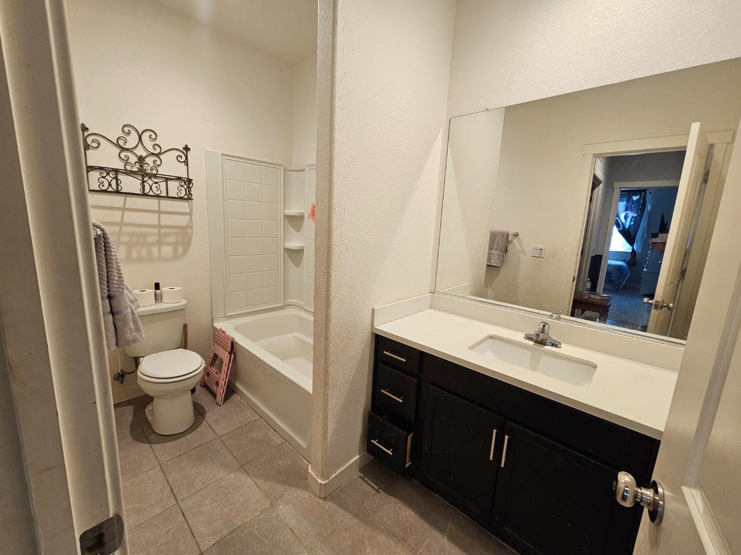 184 Raccoon Hollow Loop Copperopolis, CA 95228 - Photo 8 of 8 a bathroom with a granite countertop toilet a sink and a bathtub