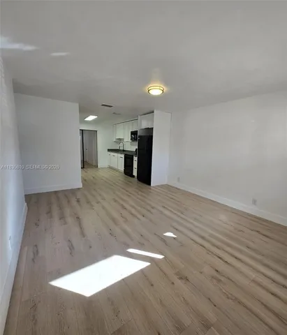 a view of a kitchen with wooden floor