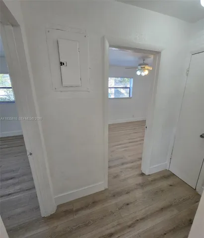 a view of empty room with wooden floor