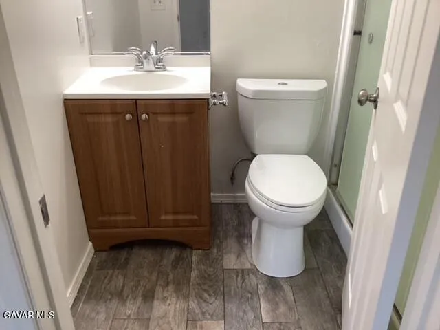 a bathroom with sink toilet and a mirror