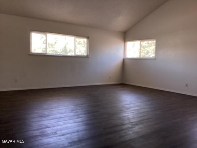 44745 Christie Avenue Lancaster, CA 93535 - Photo 14 of 18 an empty room with wooden floor and windows