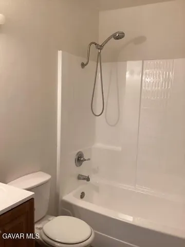 a bathroom with a shower a toilet and a sink