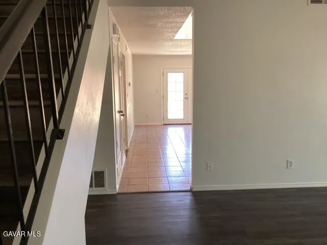 a view of an entryway with wooden floor and door