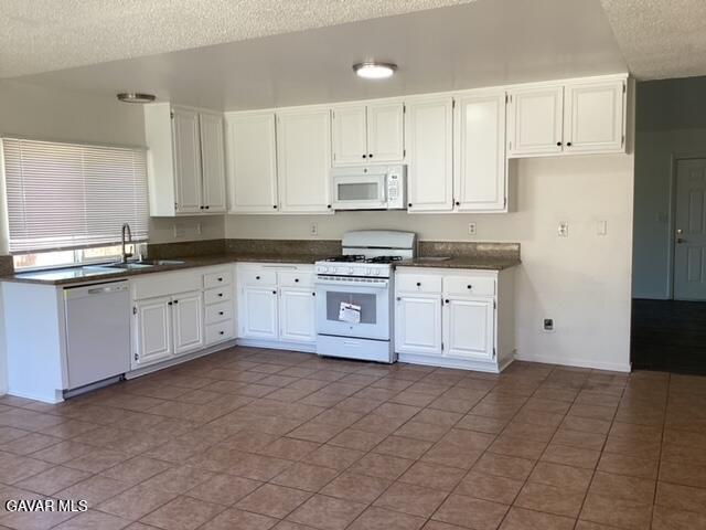 44745 Christie Avenue Lancaster, CA 93535 - Photo 6 of 18 a kitchen with granite countertop a sink stove and cabinets