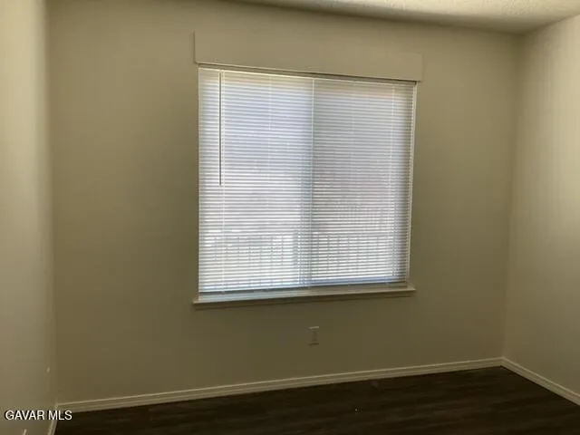 a view of a small space with wooden floor and a window