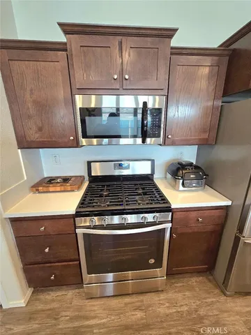 a stove top oven sitting inside of a kitchen