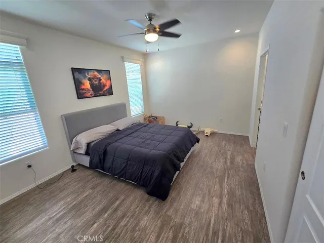 a bedroom with a large bed chandelier and a window