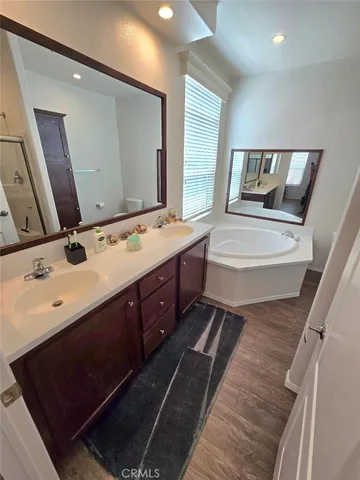 a spacious bathroom with a double vanity sink and mirror