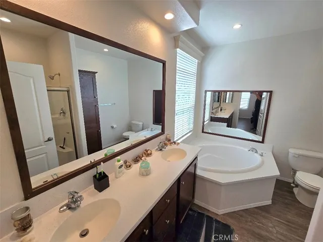 a bathroom with a tub sink and mirror