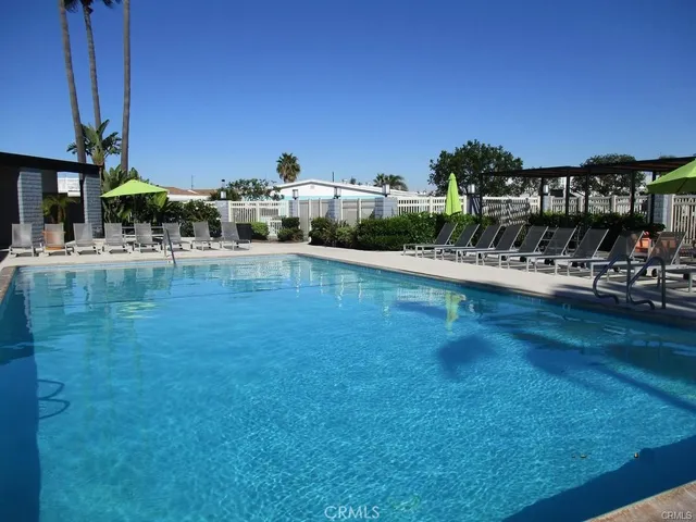 a view of a swimming pool with outdoor seating
