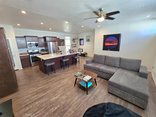 a living room with furniture and kitchen view
