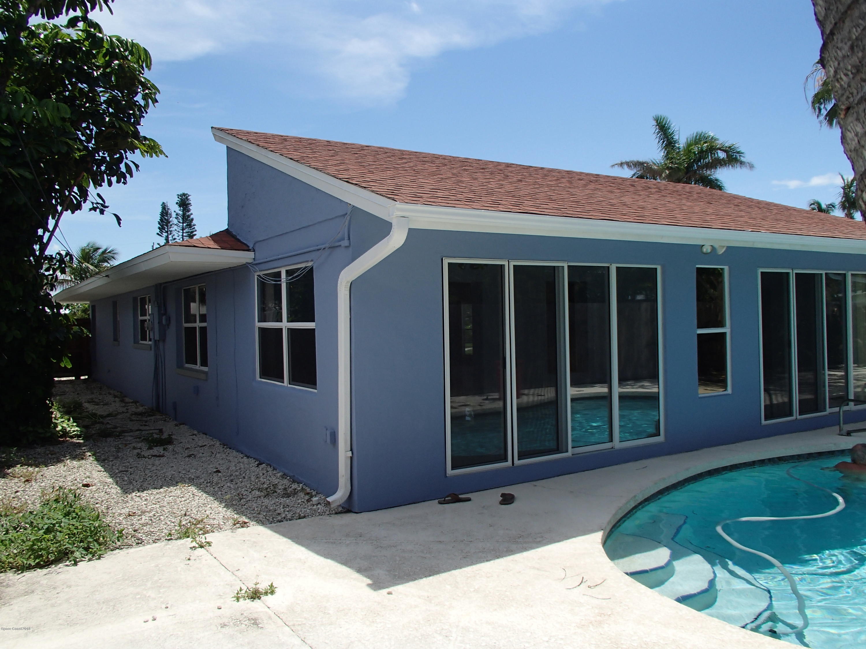 703 Bermuda Road Cocoa Beach, FL 32931 - Photo 14 of 19 a patio with a table and chairs and potted plants