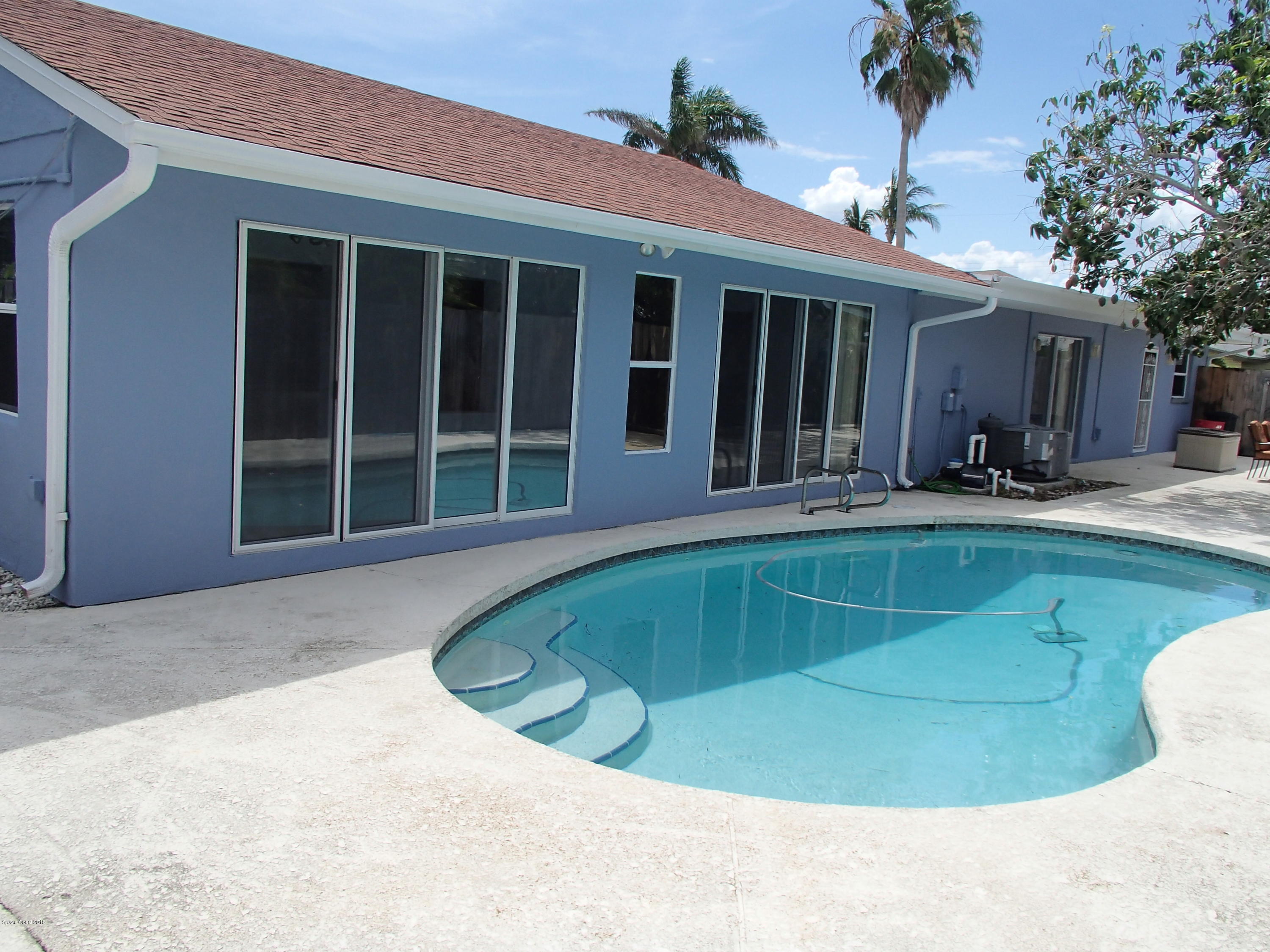 703 Bermuda Road Cocoa Beach, FL 32931 - Photo 15 of 19 a view of a house with swimming pool and porch