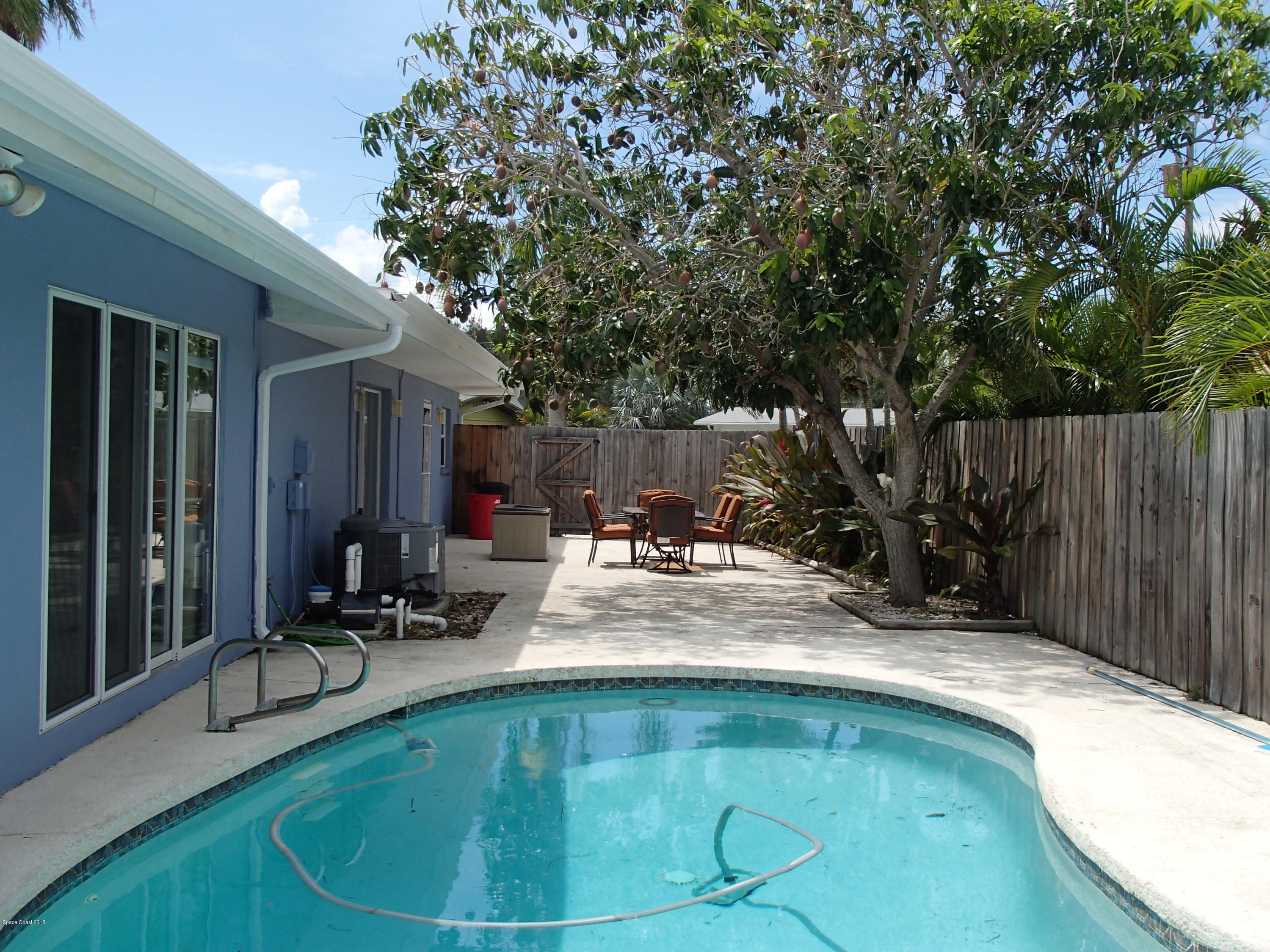 703 Bermuda Road Cocoa Beach, FL 32931 - Photo 16 of 19 a view of a house with backyard porch and sitting area