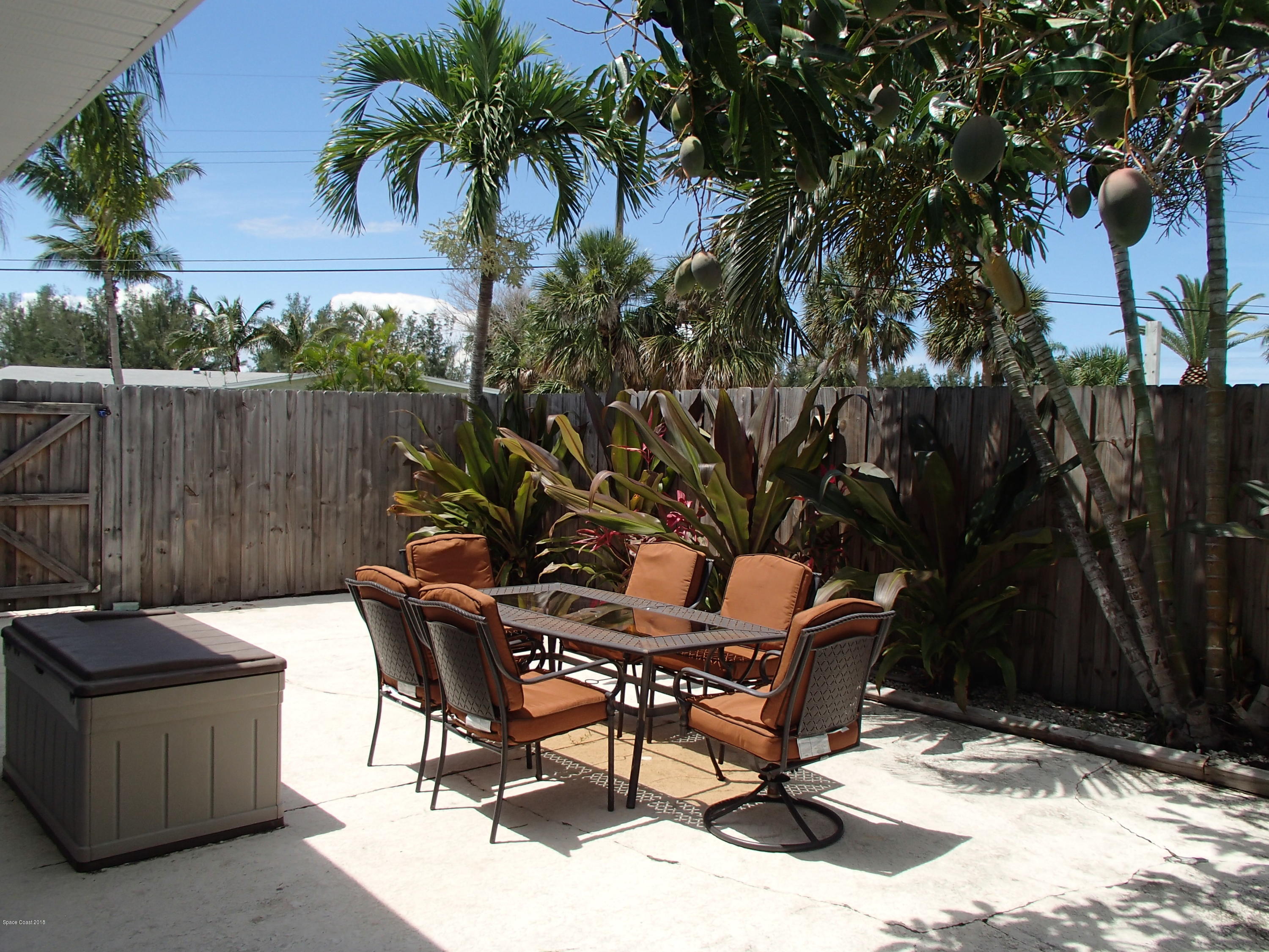 703 Bermuda Road Cocoa Beach, FL 32931 - Photo 17 of 19 a view of a backyard with a sitting area and furniture