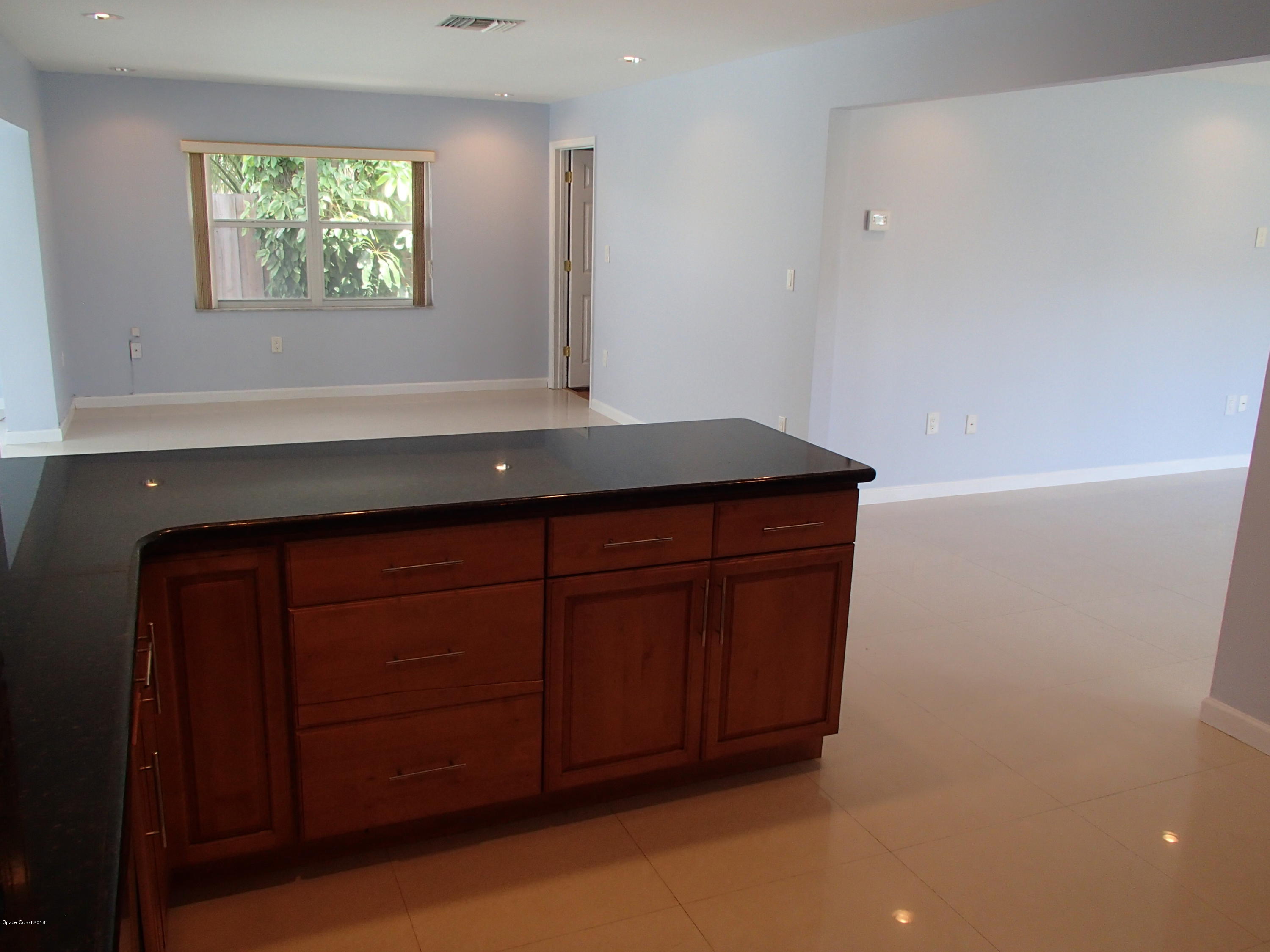 703 Bermuda Road Cocoa Beach, FL 32931 - Photo 5 of 19 a bathroom with a sink and a mirror