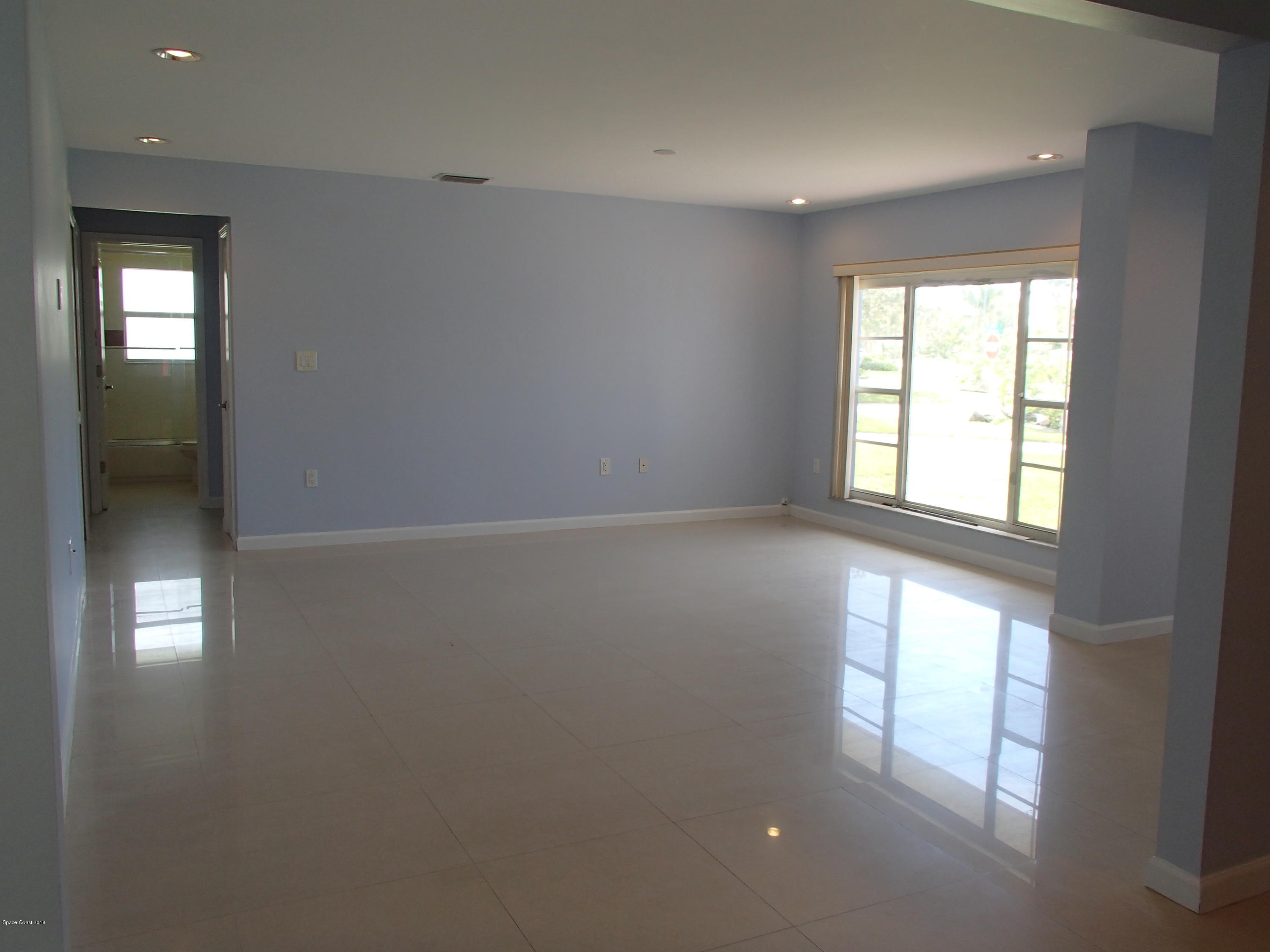 703 Bermuda Road Cocoa Beach, FL 32931 - Photo 8 of 19 an empty room with windows and closet