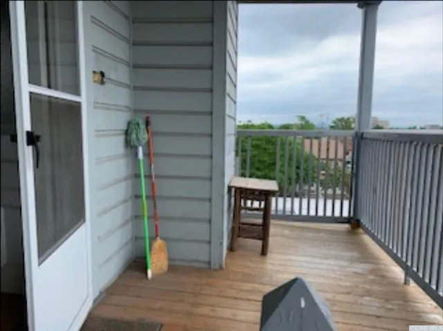 a view of a balcony with floor to ceiling window wooden floor