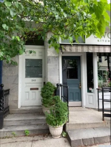 a front view of a house with potted plants