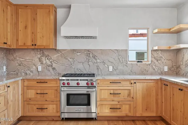 a stove top oven sitting inside of a kitchen
