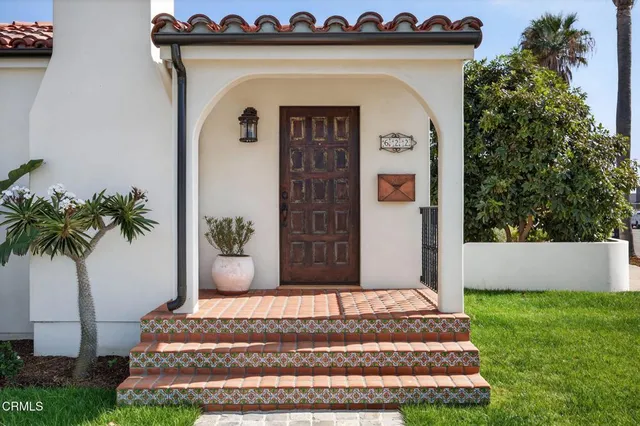a front view of a house with a garden