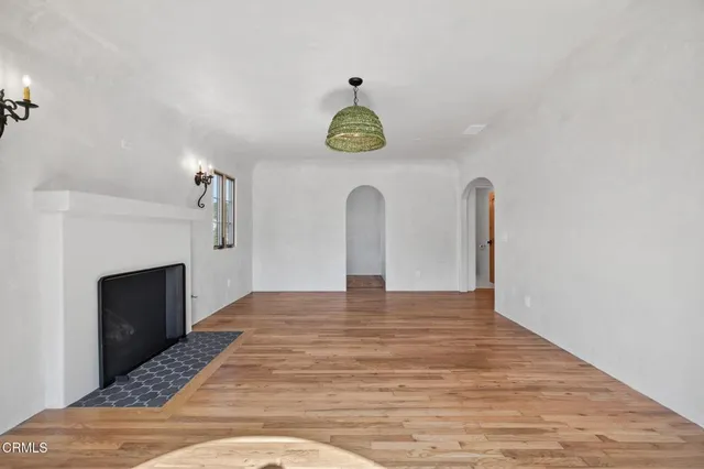 a view of empty room with fireplace and window