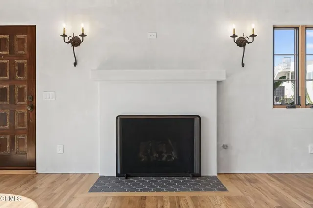 a living room with a fireplace and a rug
