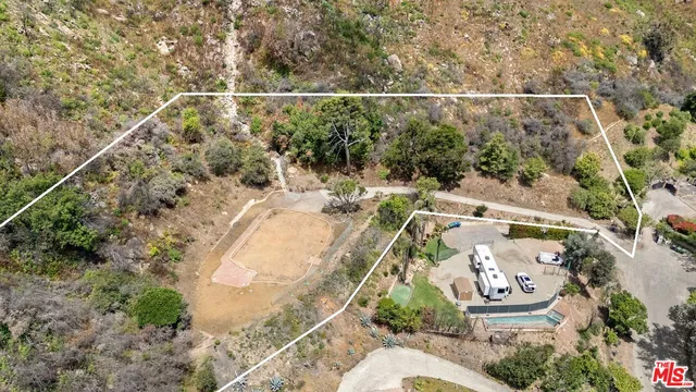 an aerial view of a house with a yard