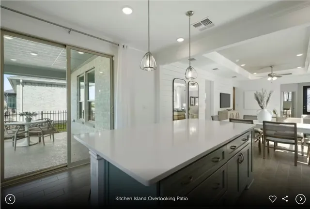 a kitchen with stainless steel appliances granite countertop a sink a counter space and a view of living room