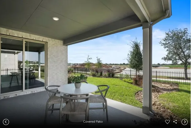 a view of a patio with a table chairs and a backyard