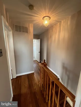 a view of a hallway to rooms