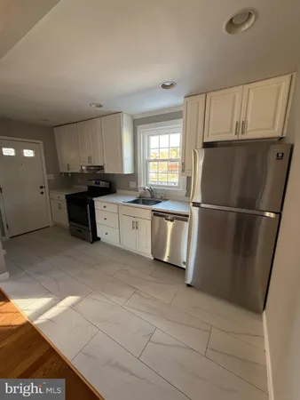 a kitchen with stainless steel appliances granite countertop a refrigerator sink and cabinets