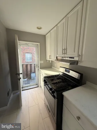 a kitchen with a stove and a refrigerator