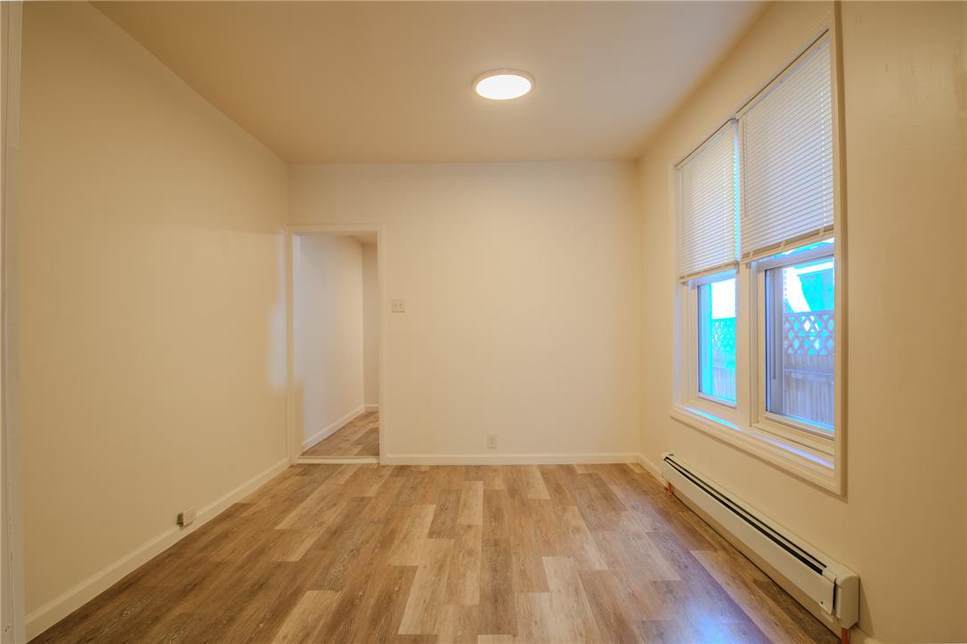 820 North 5th Street Allentown, PA 18102 - Photo 16 of 39 Newly installed wood-look flooring enhances this versatile living area, ready for your personalized touch.