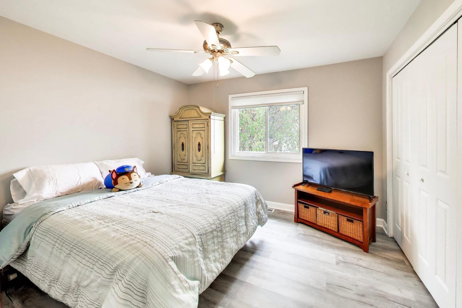 313 South Hi Lusi Avenue Mount Prospect, IL 60056 - Photo 17 of 40 a bedroom with a bed and a chandelier