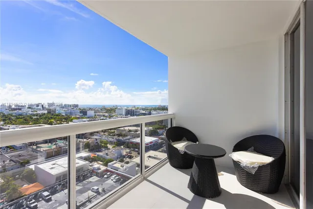 a view of a balcony with chair and a potted plant