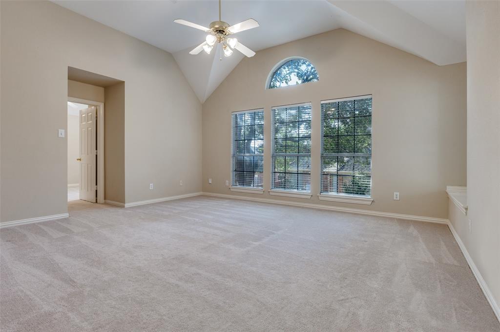 602 Signet Court Keller, TX 76248 - Photo 14 of 30 an empty room with a chandelier fan and windows