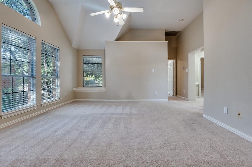 602 Signet Court Keller, TX 76248 - Photo 15 of 30 en empty room with windows and chandelier fan