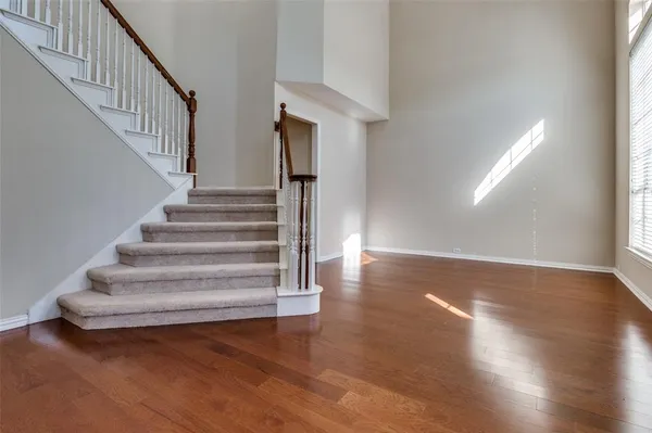 a view of entryway and hall with wooden floor