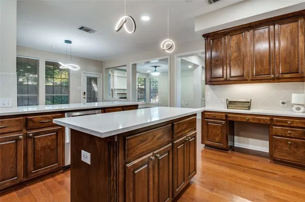 a kitchen with stainless steel appliances granite countertop stove top oven and cabinets