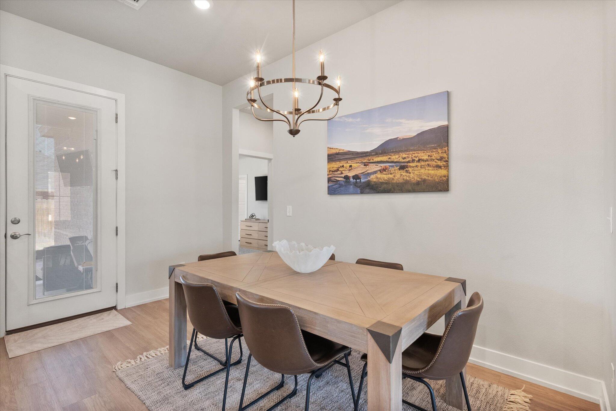 5908 Grinnell Street Lubbock, TX 79416 - Photo 12 of 27 a view of a dining room with furniture and wooden floor