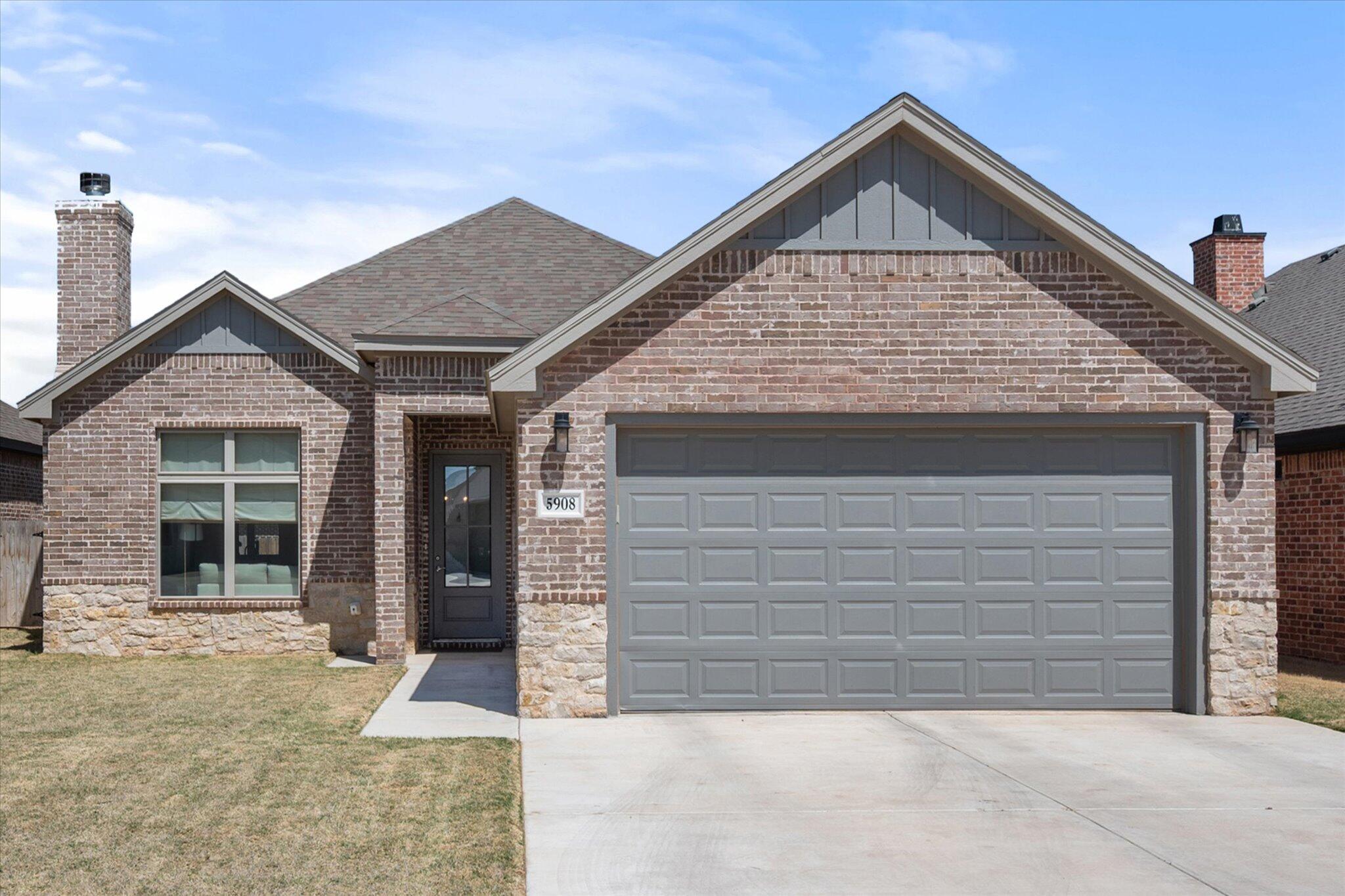 5908 Grinnell Street Lubbock, TX 79416 - Photo 2 of 27 a front view of a house with a yard and garage