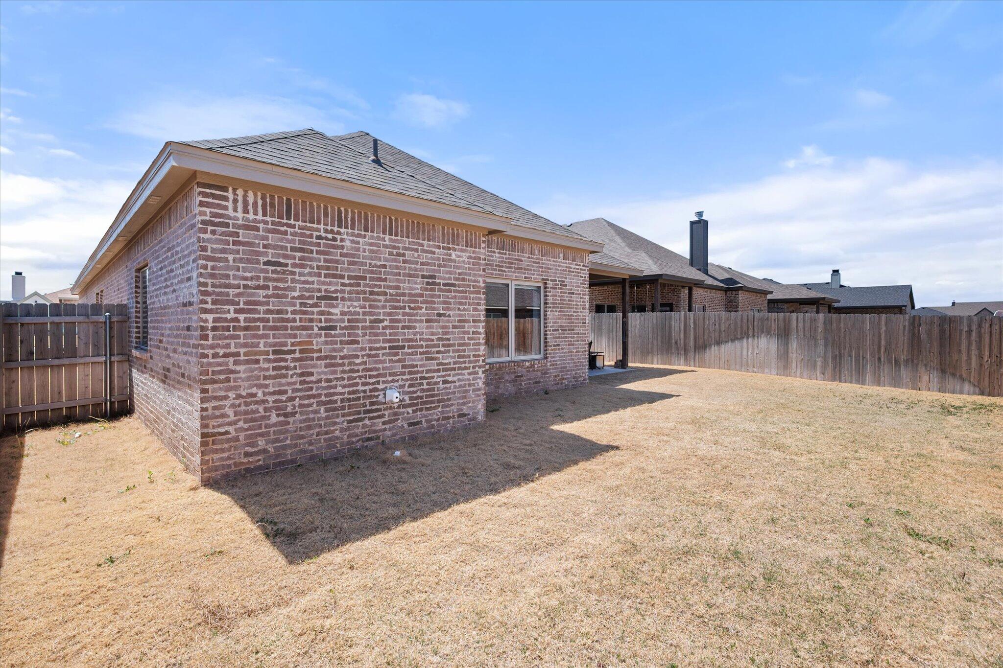 5908 Grinnell Street Lubbock, TX 79416 - Photo 24 of 27 a view of a house with a wooden fence